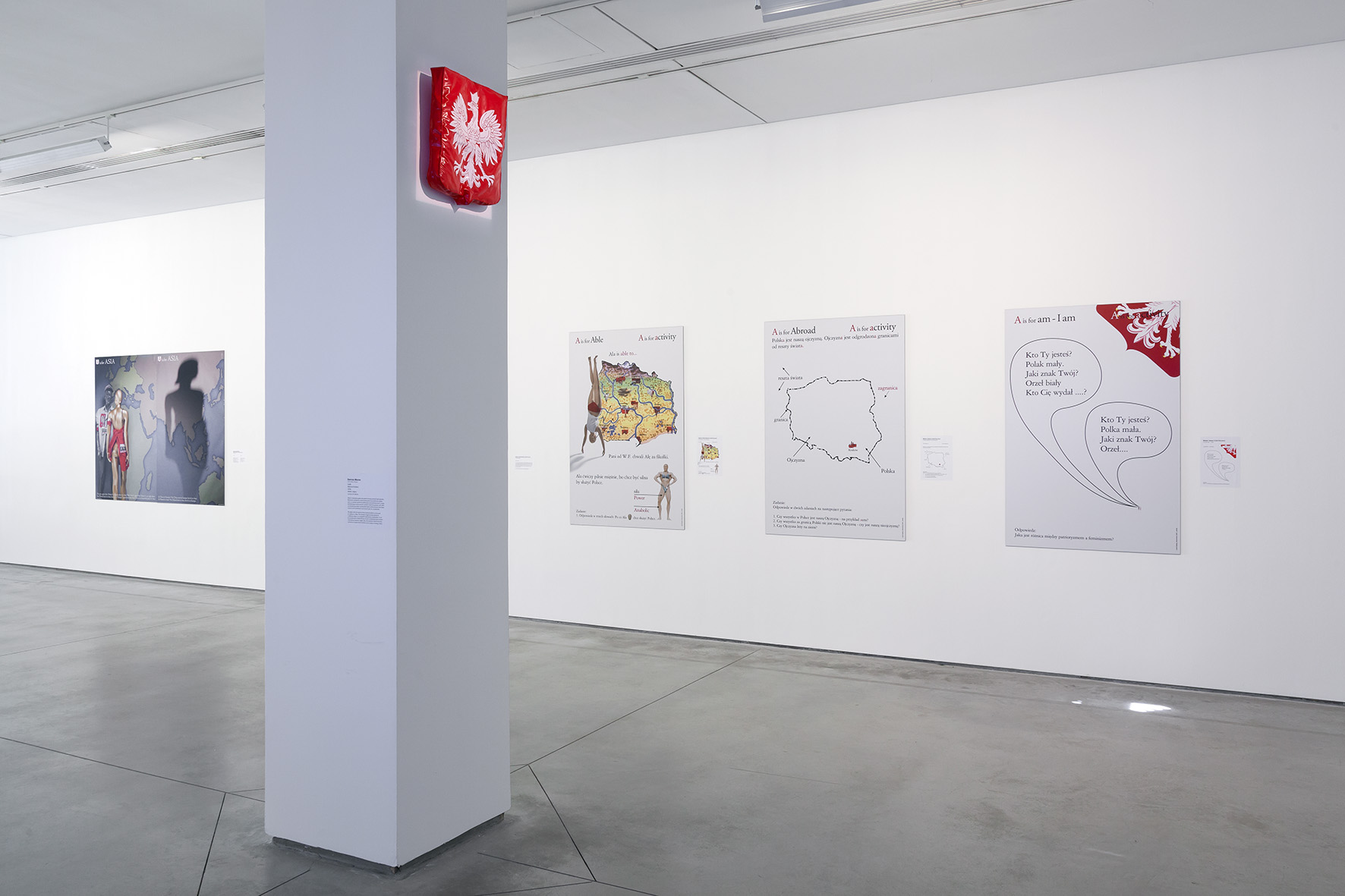 //Motherland in Art// exhibition. Foreground: Bartosz Mucha, //National Emblem//, 2006. Background, works by Łódź Kaliskia from the series //Ali-Phabet//, 2007, photo: R. Sosin