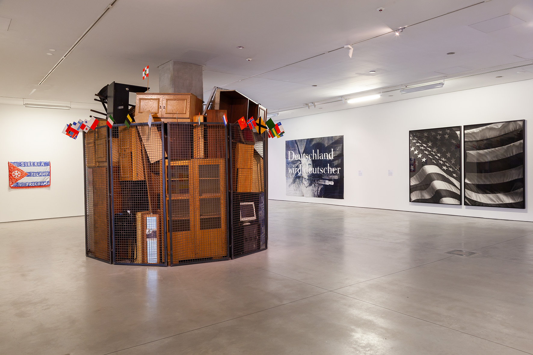 //Motherland in Art// exhibition. Foreground: Jarosław Kozłowski, //A United World – the Totalitarian Version//, 2000. Background, works by: Damir Muratov, Katharina Sieverding, Robert Longo, photo: R. Sosin