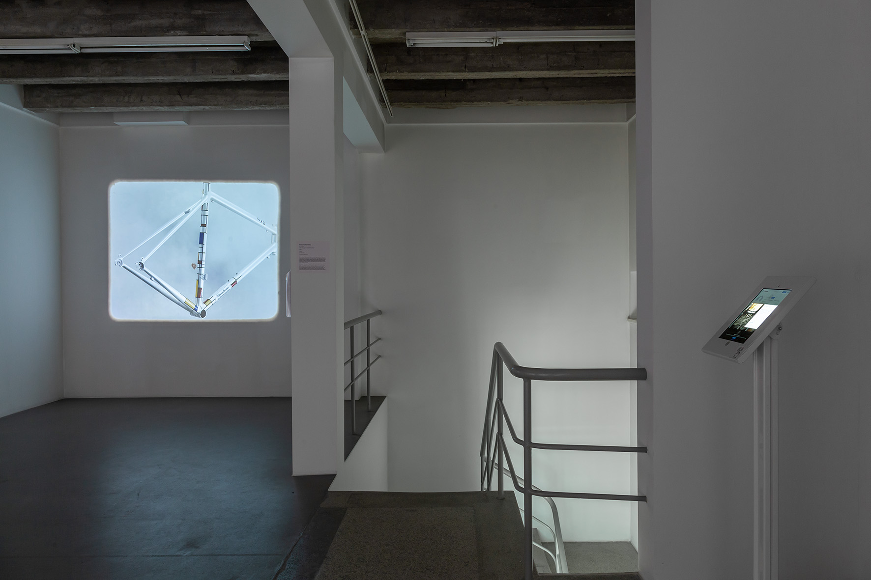 //The Studio of Łukasz Skąpski// exhibition. Background, work by Horacy Muszyński, //Hello! Attention!//, 2015, video, 14 min 15 s, courtesy of H. Muszyński, photo: R. Sosin